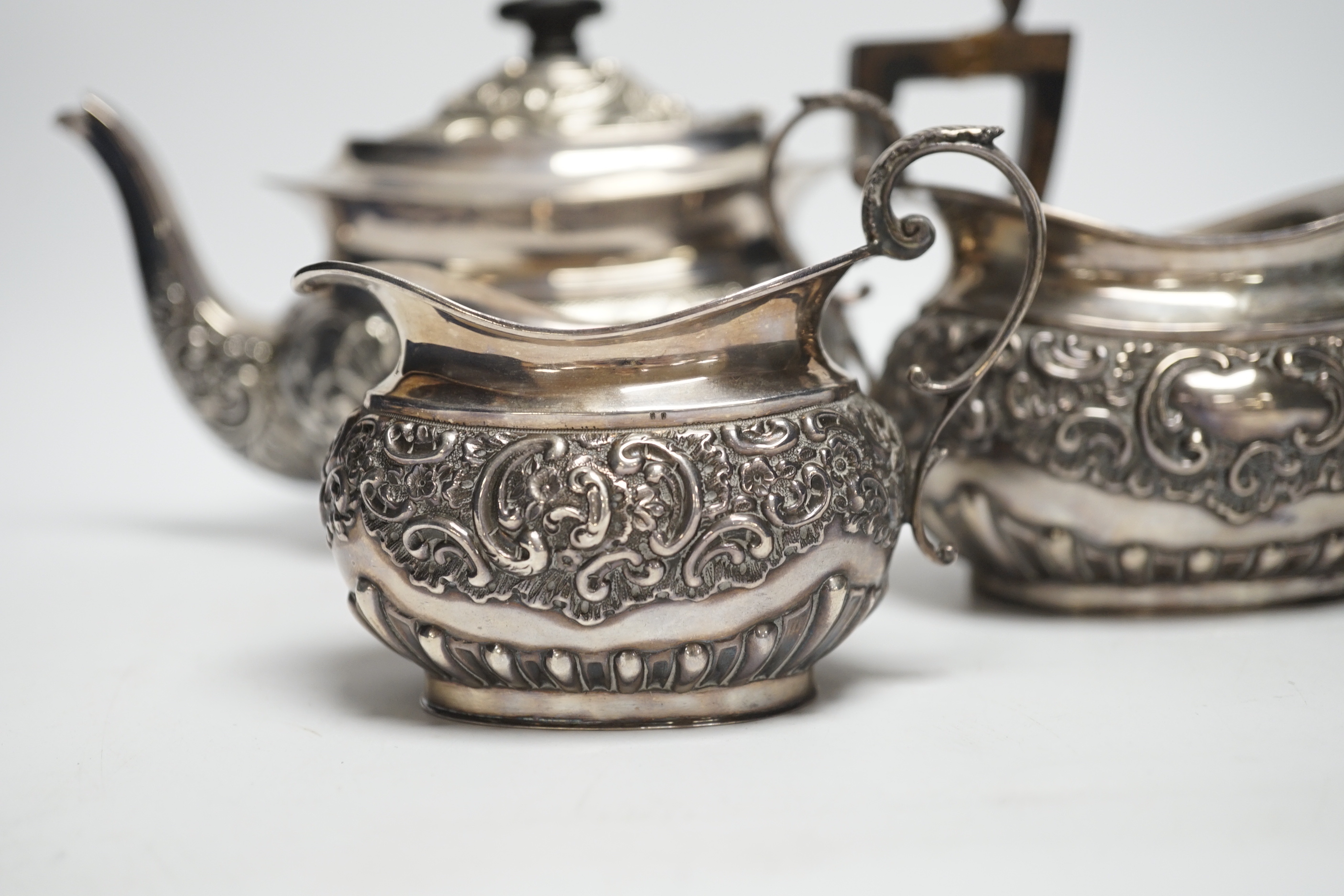 A matched late Victorian silver three piece tea set, maker's Haseler Brothers and John Round & Son Ltd, Birmingham, 1899 and Sheffield, 1900, gross weight 19.3oz.